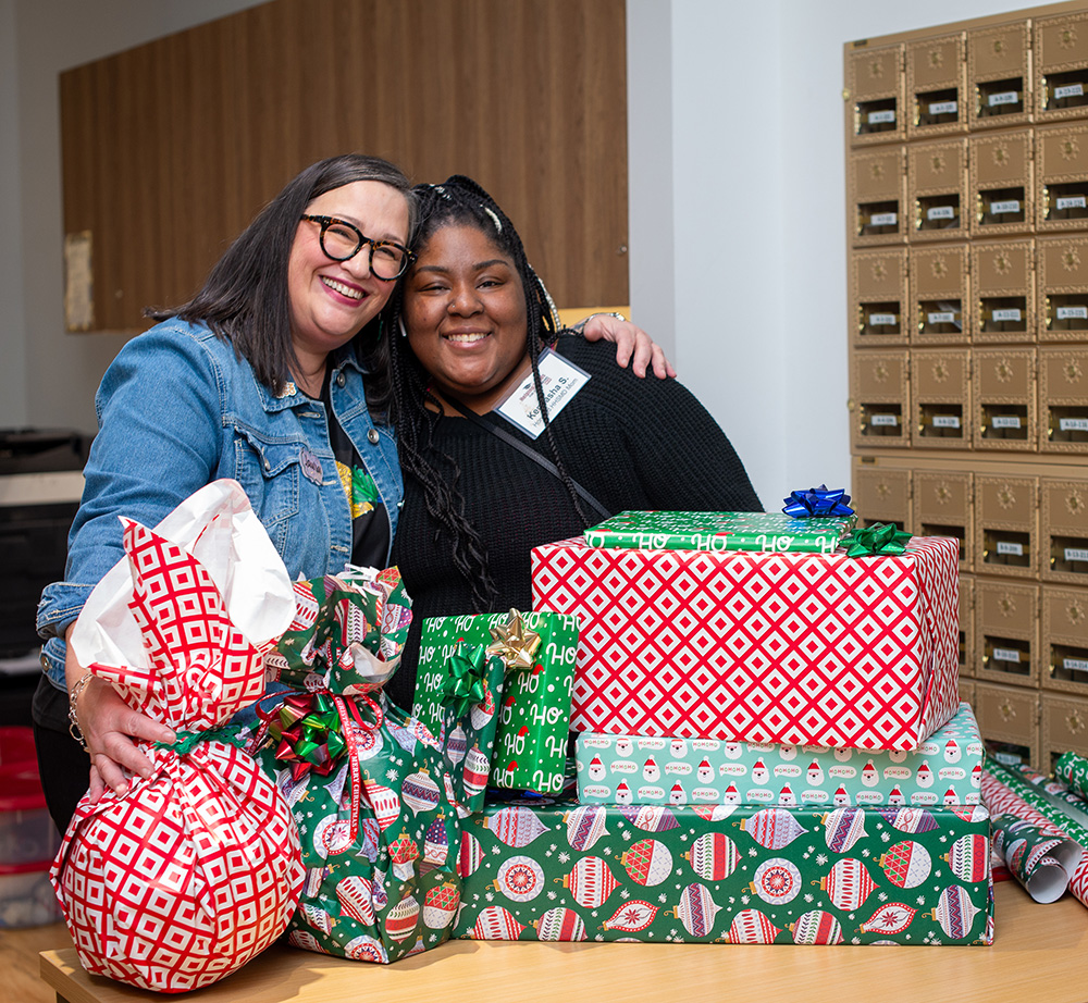 Candid lifestyle happy and cheerful mother and son in love eating tangerines in Christmas decor